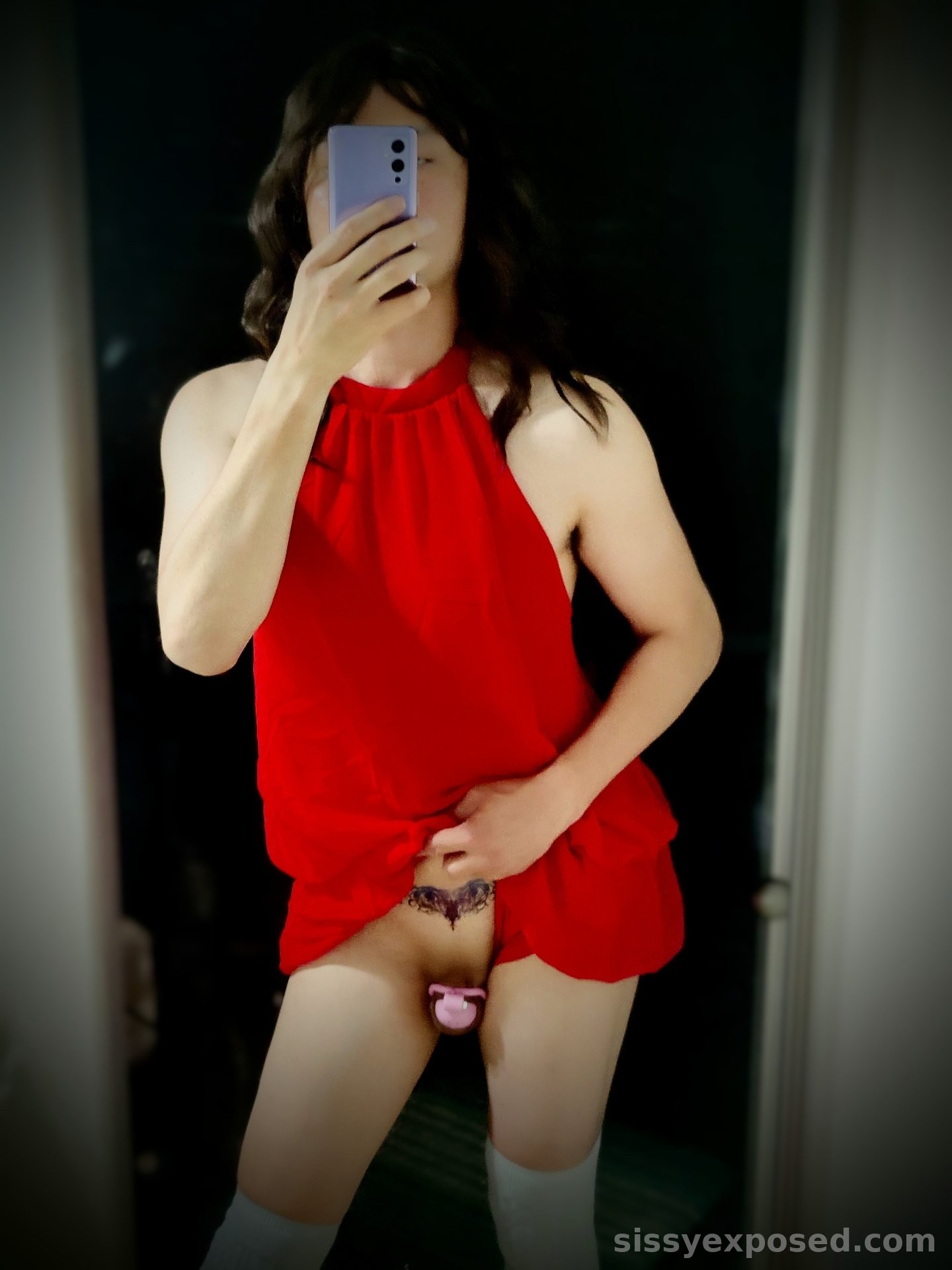Freshly minted sissy with a lewd womb tattoo and a small clit locked inside a hot pink cage
